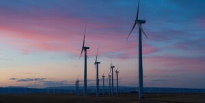 White wind mills against a sunset in the Oregon desert.